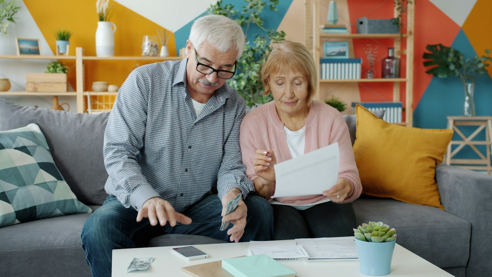 Couple reviewing financial paperwork at home, mortgage overpayment guide