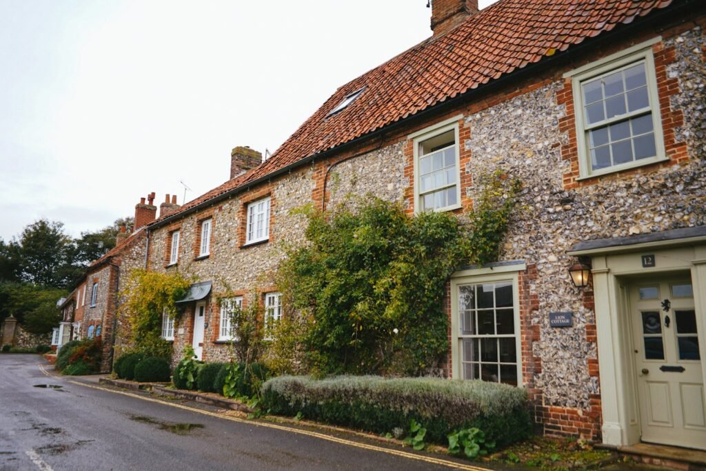 UK brick house beside green trees, mortgage affordability guide