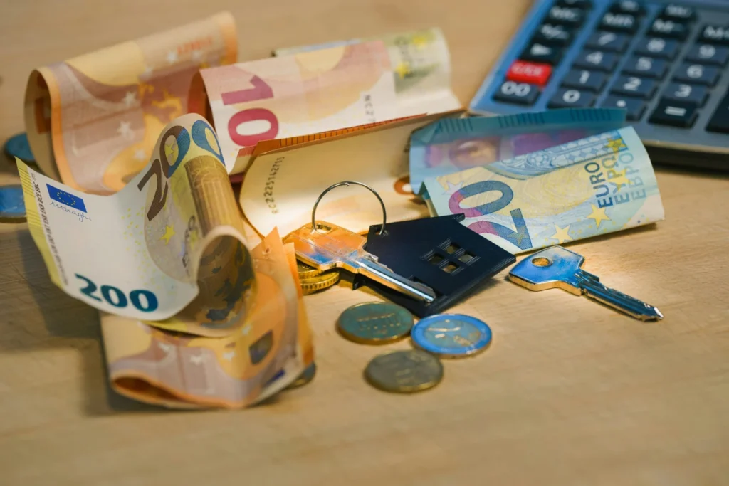 Pile of money next to a calculator, representing budgeting for a higher mortgage payment when a deal ends