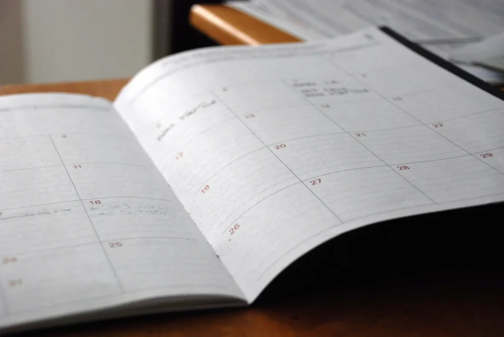 Open monthly planner on a wooden desk, used to track when a mortgage deal is ending