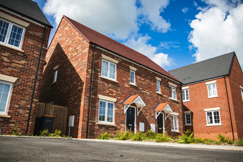 Brown brick building under a blue sky, representing UK homes with a mortgage product switch