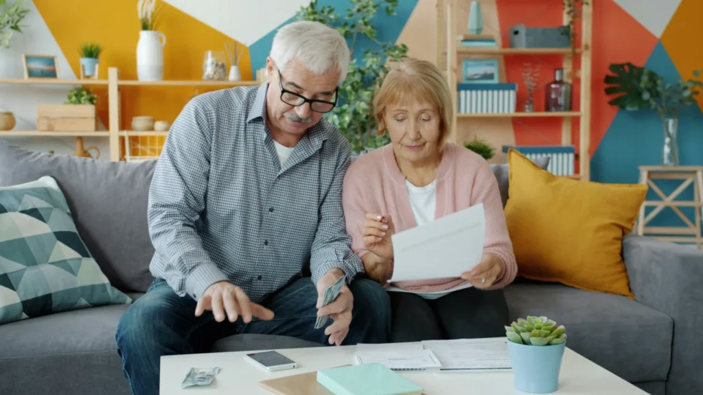 Older couple reviewing mortgage documents at home before choosing a product transfer