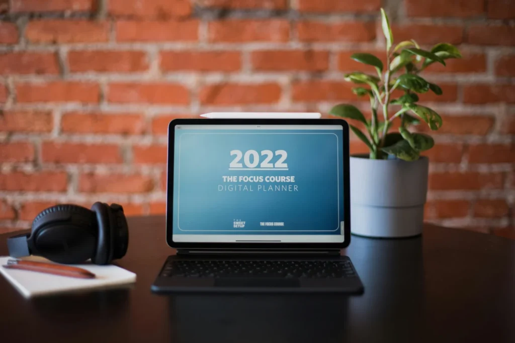 Laptop on a wooden desk, used to research mortgage product transfer options online